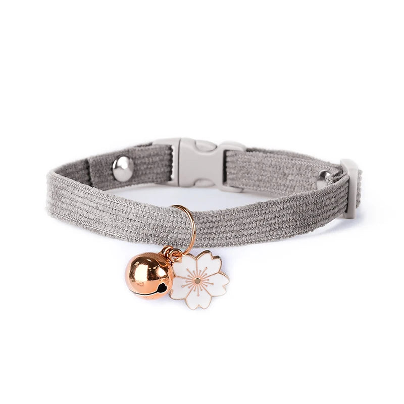 Cat collar with bell pendant, Soft kitten collar with tiny bell, Cute floral cat collar with bell, Breakaway safety cat collar with bell, Small cat collar with flower and bell, Lightweight pet collar for cats with bell, Decorative cat collar with bell charm, Adjustable kitten collar with bell, Comfortable cat collar with sound bell, Patterned cat collar with safety bell